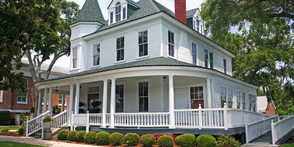 coastal Florida victorian style home with landscaped yard